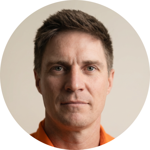 Man wearing an orange shirt with a neutral background