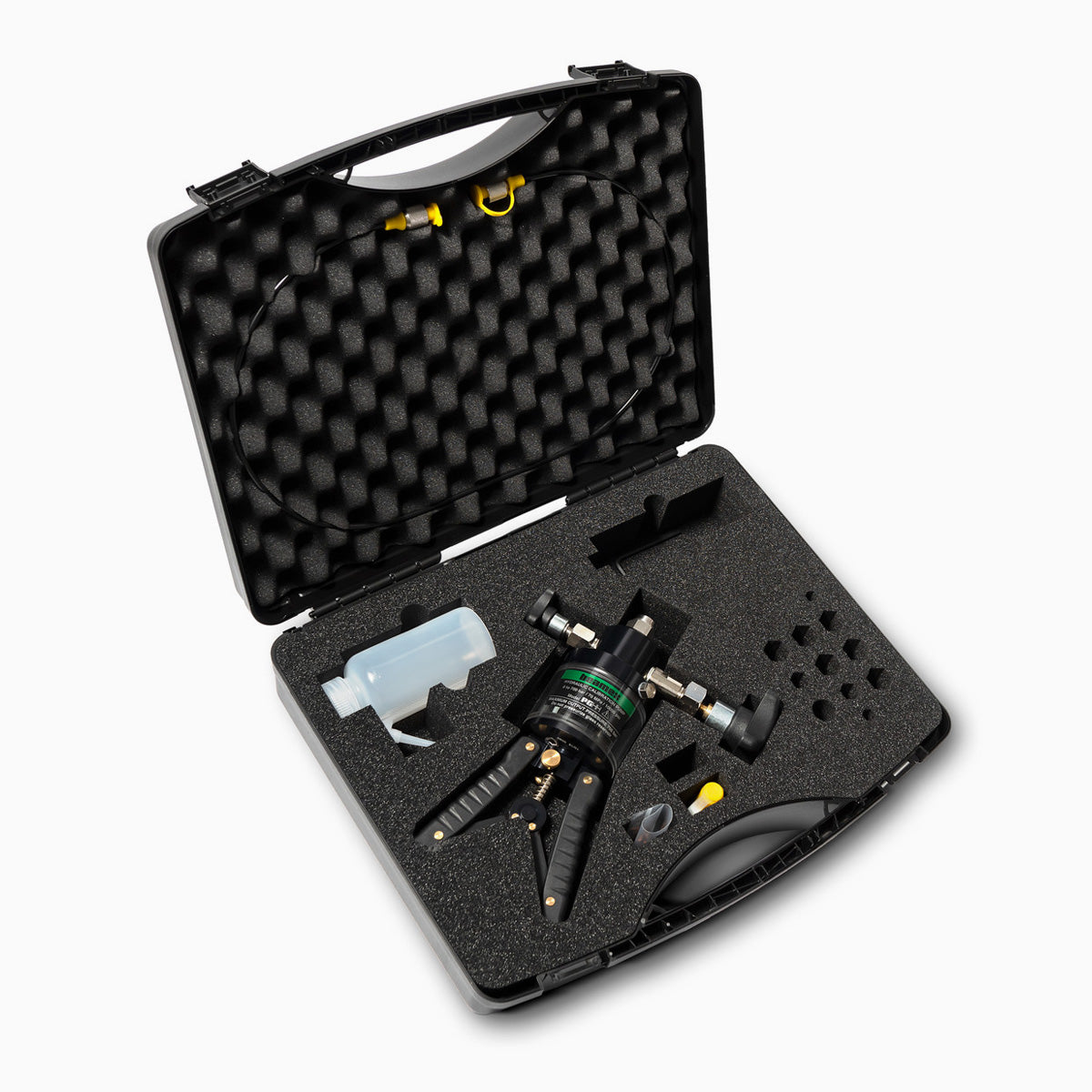 Black tool case with foam interior containing a tattoo machine and other tools on a white background