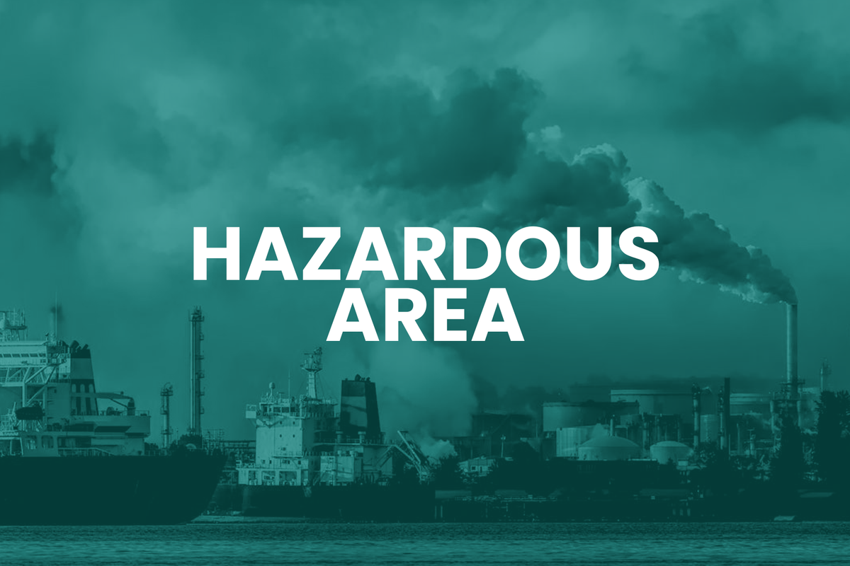 Industrial area with smokestacks emitting smoke and 'Hazardous Area' text overlay.