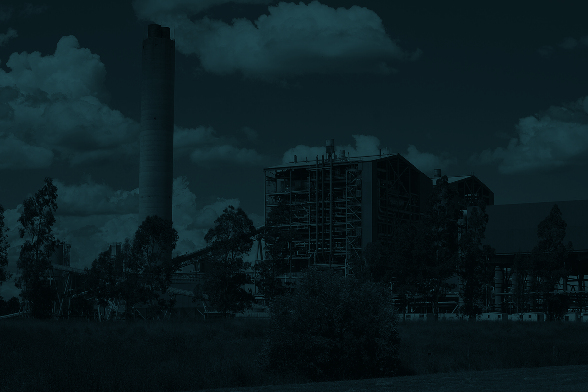 Industrial scene with a factory and smokestack under a cloudy sky
